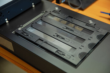 Obraz premium Digitization scanning of photographic film negatives on the scanner. Converting an image to digital form.