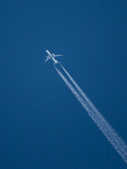 Commercial Airliner at High Altitude with Contrails