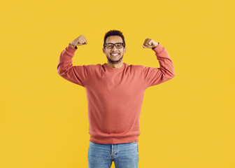 Happy cheerful positive funny young black man wearing basic orange sweatshirt and eyeglasses...
