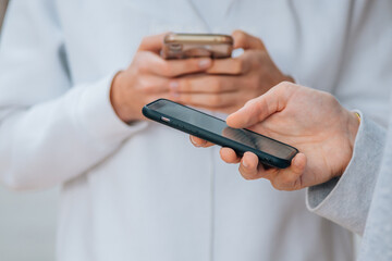 close-up of young hands with mobile phones