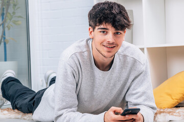 young man with mobile phone at home