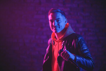 A singer man at the scene with the microphone in the neon lights concept.