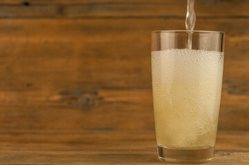 Lemonade on a glass cup on wood table