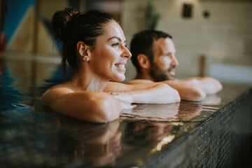 Young couple relaxing in a swimming pool