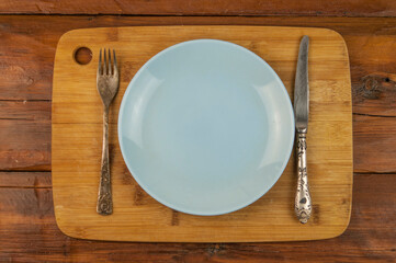 Table setting. Empty plate, knife, fork and napkin. Top view and flat lay with copy space