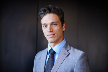 Hes a cut above the rest. Portrait of a handsome young businessman in a suit standing indoors.