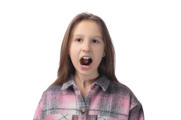 A cute little girl shows an orthodontic appliance in her mouth. The concept of teeth alignment in childhood. Studio photo on a white background.