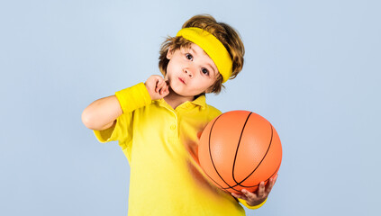 Little basketball player in sportswear with ball. Children and sport game. Active sports lifestyle.