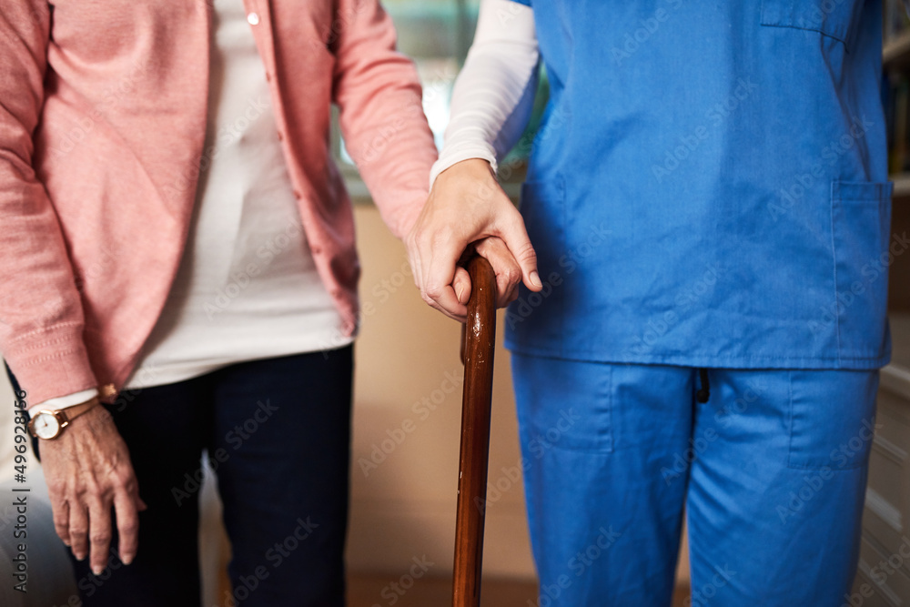 Wall mural ill be here every step of the way. shot of a young nurse assisting a senior woman whos walking with 