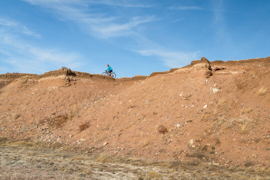 male cyclist is riding a gravel bike on cliff edge in Colorado prairie - Soapstone Prairie Natural Area