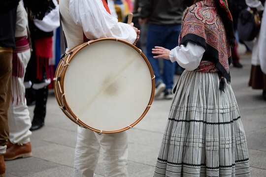 Man in period dress holding a drum at the popular festival of the reconquest of the city of Vigo, Galicia, Spain.