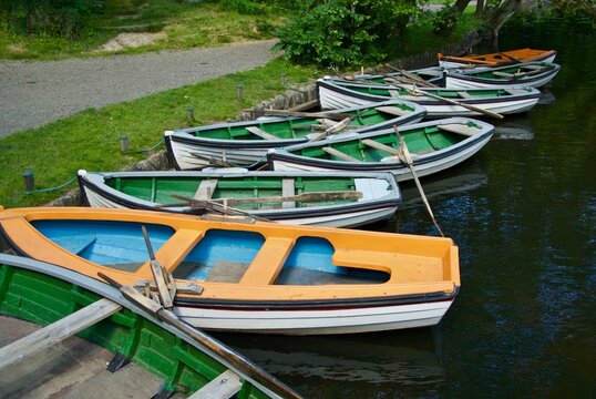 Lots of rowing boats for hire lies at the quay side in an amusement park in Bornholm.