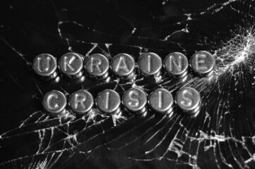 The inscription Ukraine, crisis on the broken glass. Black and white photo.