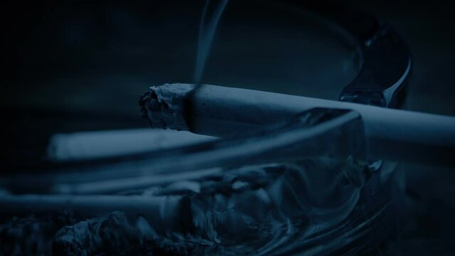 Cigarette Smoking On Ash Tray In Dark Room