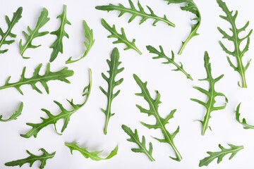 Green arugula leaves on white isolated background