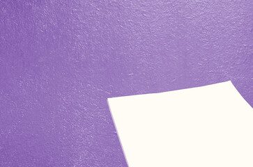 The background is made of an old purple-colored board, with a blank sheet of paper for text