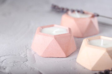 a candle made of soy wax in a plaster mold. natural handmade interior candles.