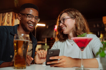 colleagues out for dinner checking cellular device
