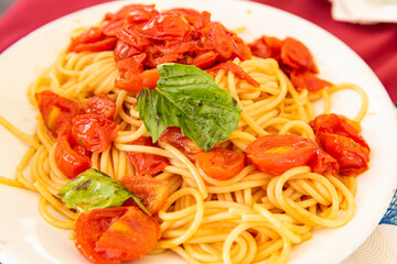 delicious spaghetti with tomato sauce in a white dish