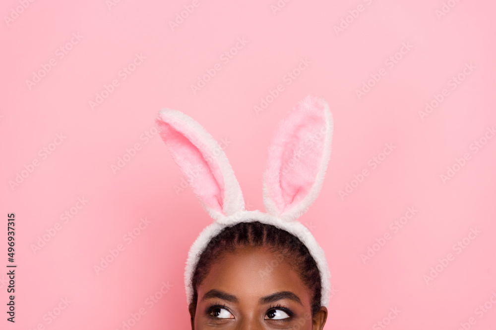 Wall mural Portrait of dreamy person half face look interested empty space isolated on pink color background