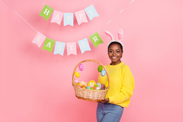 Photo of charming positive girl hold easter food basket have good mood isolated on pink color background
