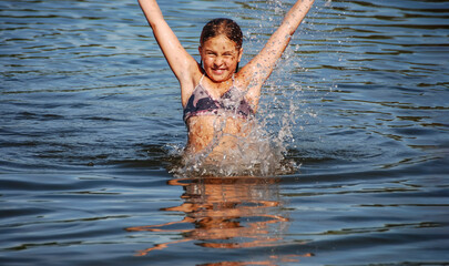girl in a bathing suit on the sea, a happy child on a sea holiday
