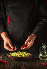 Preparation of salad from viburnum and cabbage. The chef prepares a salad for breakfast or lunch in the kitchen. European cuisine