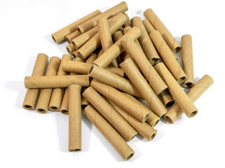 Pile of cardboard tubes on white background.