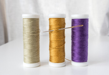 Spools of thread with a needle . Sewing workshop, atelier.