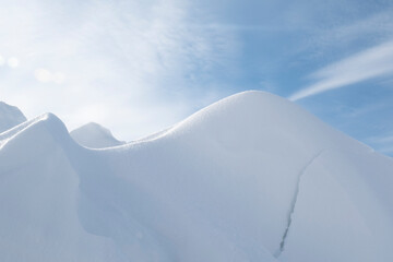 A large pile of snow after a blizzard and snowfall looks like mountain peaks.