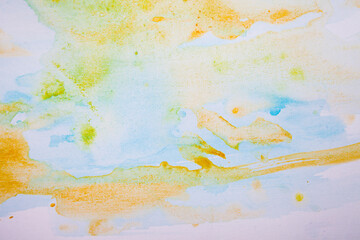 watercolor spots of yellow and blue on a white background. texture. bright spots and splashes of paint on the paper. 