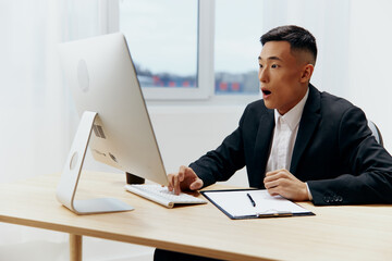 Asian man works at the computer emotion office Lifestyle