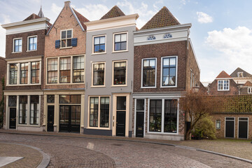 Old historic houses on a narrow street in the center of the city of Dordrecht.