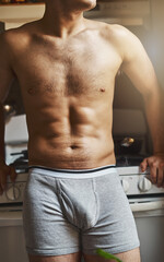 Obraz premium Some early morning contemplation. Cropped shot of an unrecignizable shirtless man in the kitchen at home.