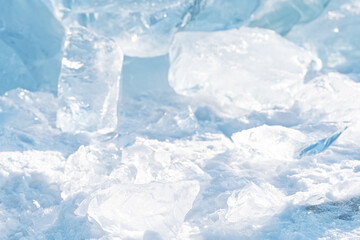 Obraz premium Ice hummocks on Baikal Lake. Transparent blue ice floe at sunset. Natural background.