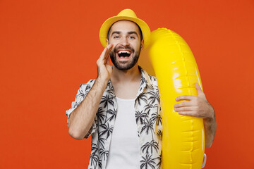 Young fun tourist man wear beach shirt hat hold inflatable ring scream hot news about sales...