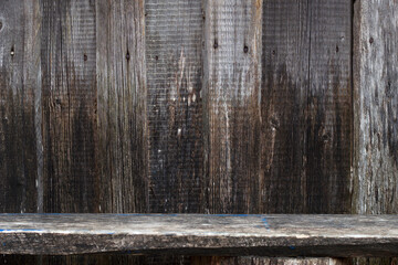 old weathered grey wall with bench as a wooden background