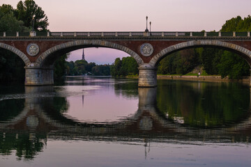 Fototapeta na wymiar Beautiful sunset view of the arch bridge over the river Po in the city of Turin, Italy