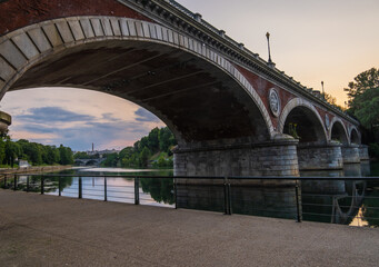 Beautiful sunset view of the arch bridge over the river Po in the city of Turin, Italy