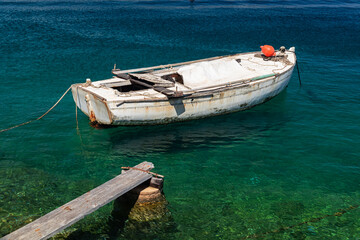 Naklejka premium boat moored at the wooden pier in harbour of Losinj town, Croatia.