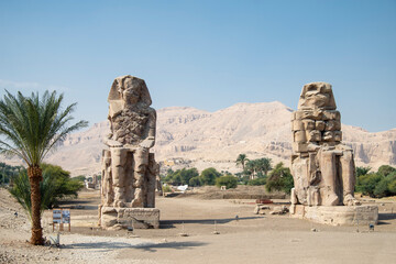 The Colossi of Memnon. Giant stone statues representing Pharaoh Amenhotep III during the 18th Dynasty of Egypt, in front of the Egyptian city of Luxor.