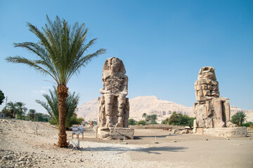 The Colossi of Memnon. Giant stone statues representing Pharaoh Amenhotep III during the 18th...
