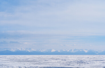 Winter landscape with mountains and Lake Baikal in Siberia at sunset. Natural background.
