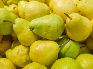 Food background yellow and green fresh ripe pears, close-up view from above, organic fruit concept
