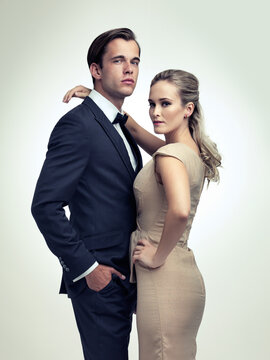 An air of sophistication. A studio portrait of a couple in stylish vintage evening wear.