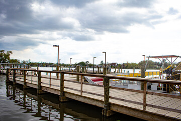 Fototapeta premium A Dock Extends into the Waterfront for Airboats to Park at in Lafitte, Louisiana, USA