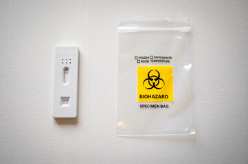Product Photo of Negative COVID Antigen Test Product Next to Biohazard Small Clear Bag Isolated on White Background. Image of overcoming the Pandemic