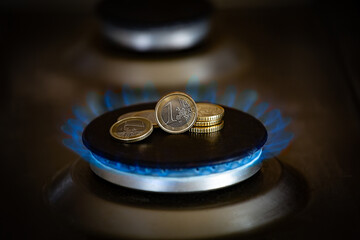 The concept of paying for gas in rubles, Euros on a burning gas burner