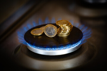 The concept of paying for gas in rubles, Euros on a burning gas burner