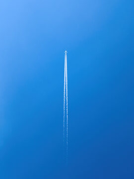Passenger airplane in flight in clear blue sky © Bits and Splits
